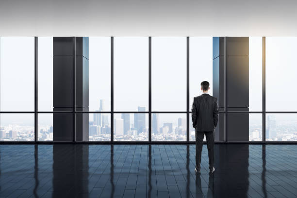 istock Businessman in bright office interior 1187698645