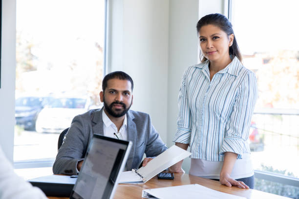 istock Serious business partners at work in board room 1187701636
