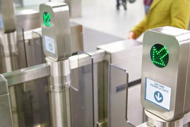 Toronto TTC Metrolinx Presto machines at a busy Bloor and Yonge station.  A contactless smart card is used to gain access to public transportation.