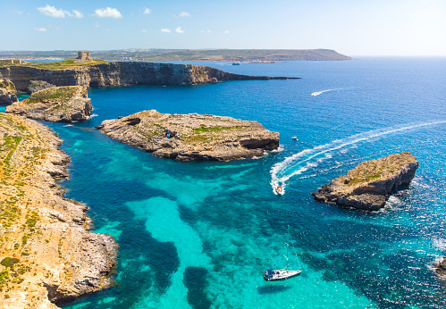 Aerial view of Comino island and a few boats o the sea. Drone landscape. Europe. Malta