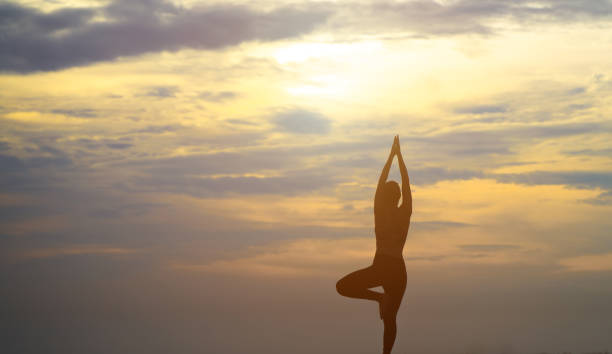 istock woman is practicing yoga at seashore 1187709988