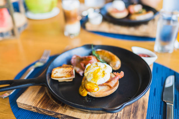 istock Breakfast set with egg benedict sausage in hot pan 1187712044