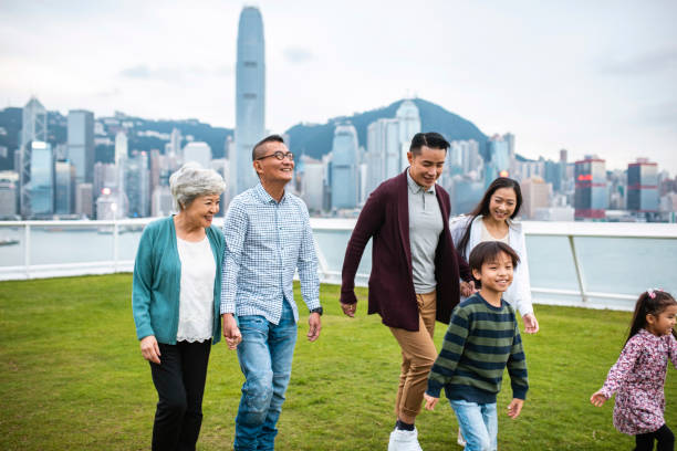 chinese family visiting ocean terminal deck on city break - harbour city imagens e fotografias de stock