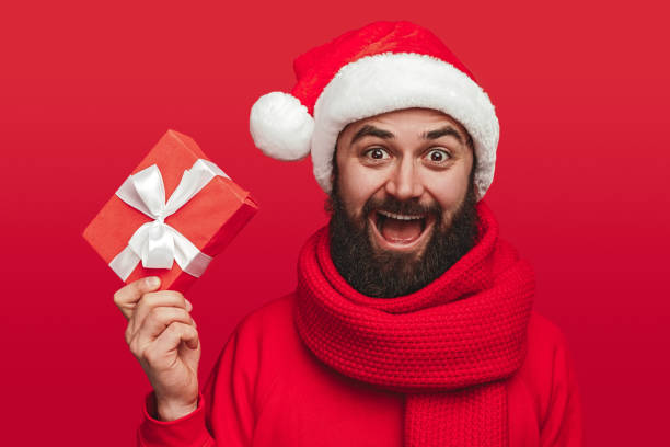 istock Happy man showing gift box during Christmas party 1187713375