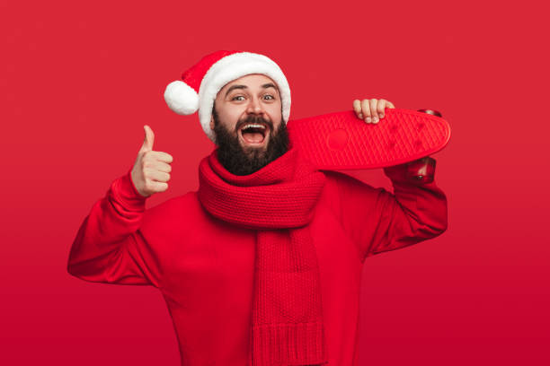 istock Cheerful hipster with skateboard approving Christmas party 1187713378