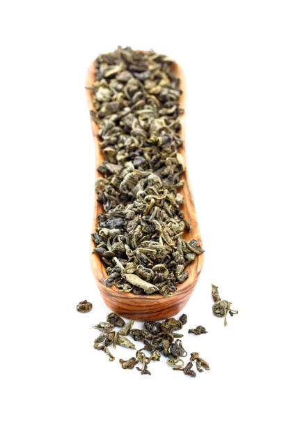 istock Green tea in small wooden dish isolated on  white. 1187717006