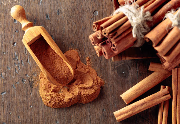 istock Cinnamon sticks and powder on a wooden table. 1187717007
