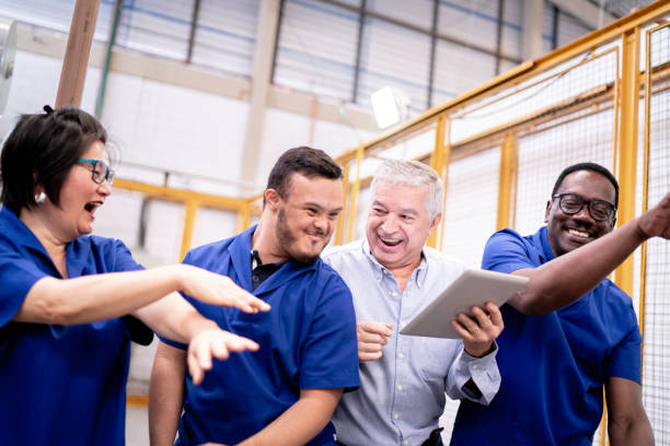 istock Happy colleagues celebrating and dancing in industry 1187717940