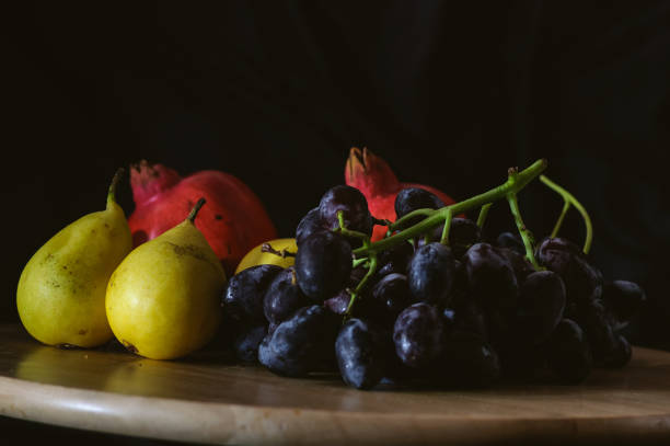 istock still life pears and black grapes on a black background 1187718757