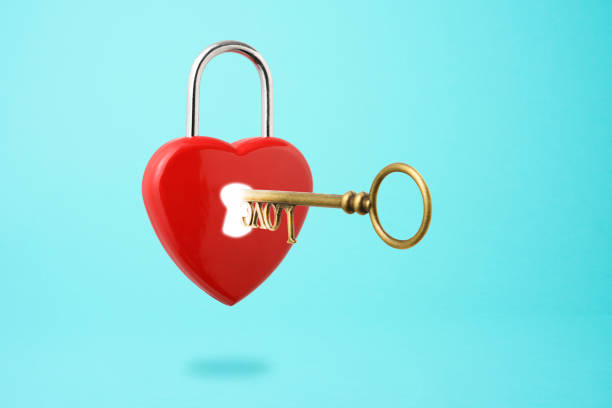 istock Inserting old skeleton key in a heart shape padlock floating in mid- air 1187722793