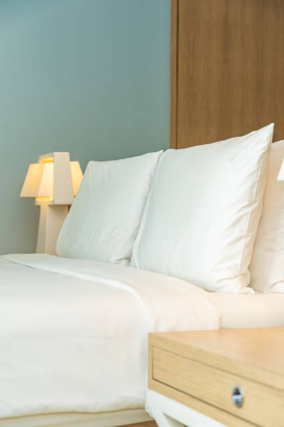 istock Pillow and blanket on bed with light lamp decoration interior 1187732623