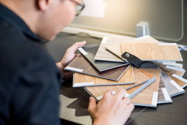 istock Asian architect man choosing wooden color swatch 1187745513