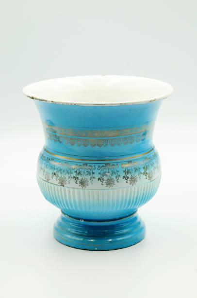 istock Blue enamel spittoon with a golden lines decoration on white background 1187745602