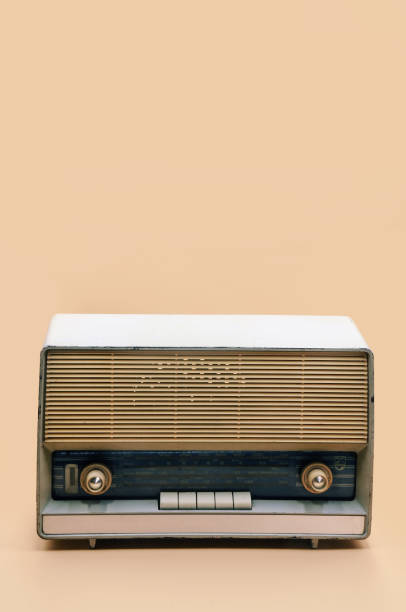 istock Retro broadcast radio receiver on peach color background 1187745609