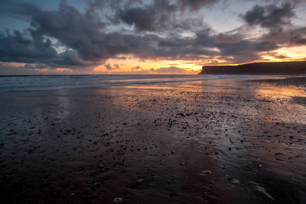 istock Sunrise over an empty beach on low tide at Saltburn by the sea 1187750418