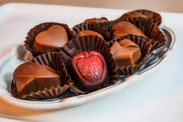 istock close up special chocolates with different figures in white plate on white background. 1187751174