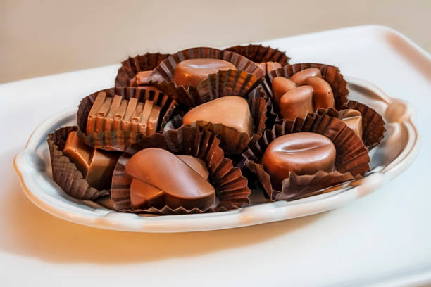 istock close up special chocolates with different figures in white plate on white background. 1187751288
