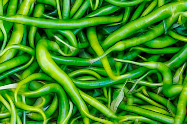 close up ready to eat green peppers in market stall