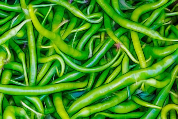 close up ready to eat green peppers in market stall