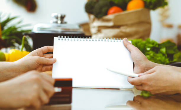 istock Closeup of human hands discussing something while cooking in kitchen. Women talking about menu. Family dinner, friendship and lifestyle concept 1187758632
