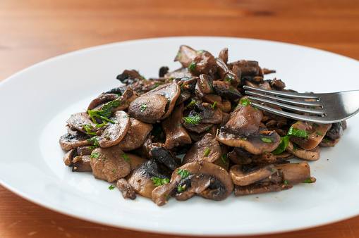 Sauteed champignon mushroom with chopped parsley