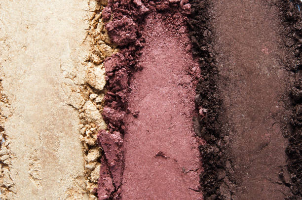 Texture of broken eyeshadow or powder. The concept of fashion and beauty industry. Close-up. - Image Texture of broken eyeshadow or powder. The concept of fashion and beauty industry. Close-up. - Image eyeshadow stock pictures, royalty-free photos & images