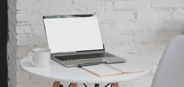 istock Cropped shot of outdoor comfortable workplace with open blank screen laptop computer and office supplies 1187766611
