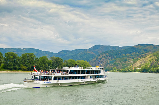 Dürnstein, Austria - August 13th 2018:\nThe passenger ship (MS Austria of the Company Brandner) on the River Danube, upstream in the direction of Melk.