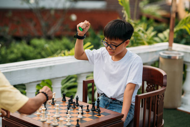 istock Asian grandfather teaching his grandson playing chess 1187767412