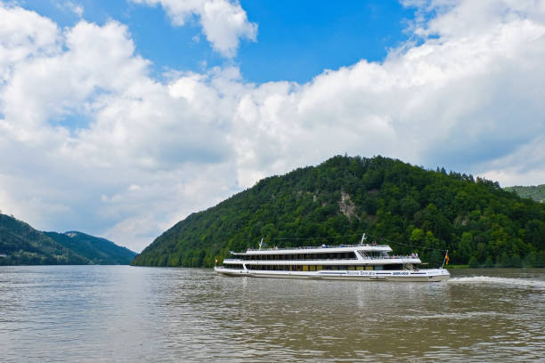 Schlögen, Austria - September 5th 2017:\nThe passenger ship (MS Regina Danubia of the Company Wurm + Köck) on the Danube. The ship passes the „Schlögener Schlinge“ upstream in the direction of Passau.