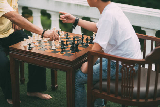 istock Asian grandfather teaching his grandson playing chess 1187767430