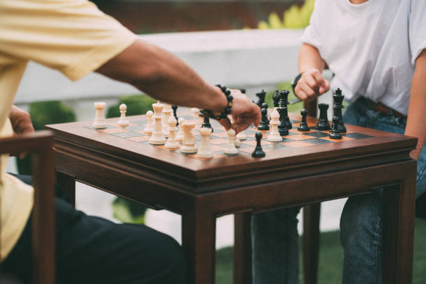 istock Asian grandfather teaching his grandson playing chess 1187767445