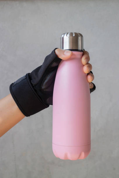 istock Fitness glove hand on water bottle 1187767613