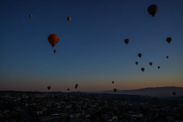 Sunrise panoramic view to Goreme city and flying balloons, Cappadocia, Turkey Sunrise panoramic view to Goreme,Uchisar city and flying balloons over pigeon valley Cappadocia, Turkey niğde city stock pictures, royalty-free photos & images