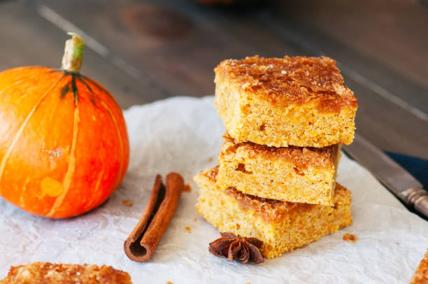 Pumpkin cornmeal bars on a wooden background.