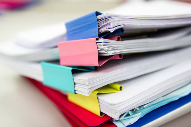 istock file folder and Stack of business report paper file on the table in a work office 1187773999