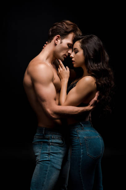 beautiful seductive girlfriend and boyfriend hugging, isolated on black beautiful seductive girlfriend and boyfriend hugging, isolated on black sensuality stock pictures, royalty-free photos & images