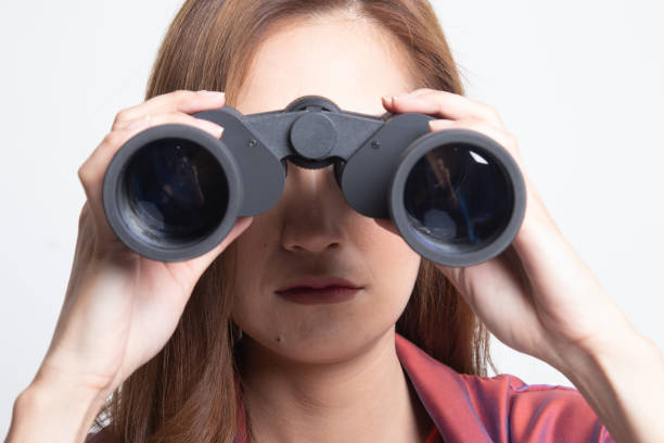 istock Young Asian woman with binoculars. 1187775472
