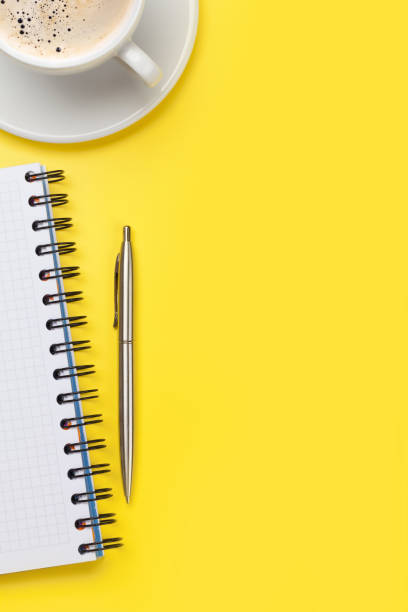 istock Office yellow workplace with coffee cup and supplies 1187776373