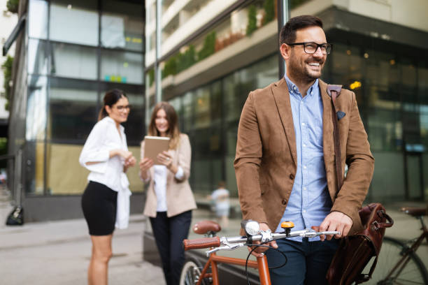 istock Happy businessman riding bicycle to work in morning 1187776433
