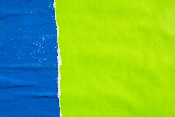 istock Blue and green torn and ripped shabby paper posters and placards on rough surface texture background. Can be used for text. 1187779414
