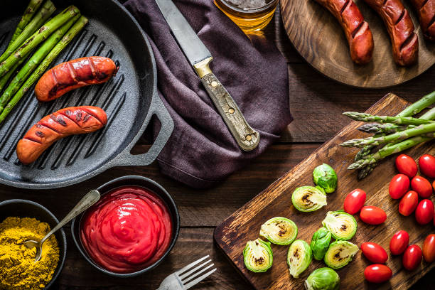 istock Grilled German sausages with curry, ketchup sauce and vegetables 1187784596