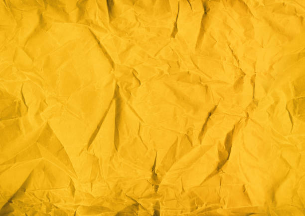 istock yellow crumpled paper texture background 1187785175