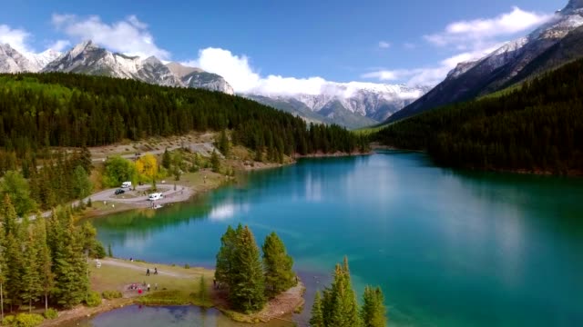 Aerial drone shot of lush greenery of Two Jack Lake in Banff National Park, Alberta, Canada.