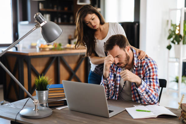 istock Frustrated couple checking bills at home using laptop 1187793829