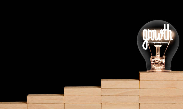 istock Light Bulb and wooden block ladder with Growth Concept 1187794486