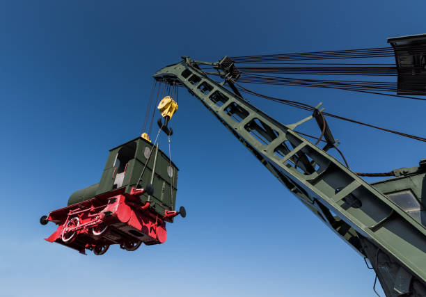 powerful rail crane raises the locomotive stock photo