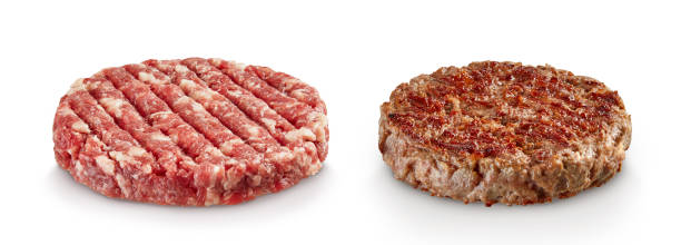 istock Raw and cooked hamburger patties isolated on white background 1187796882