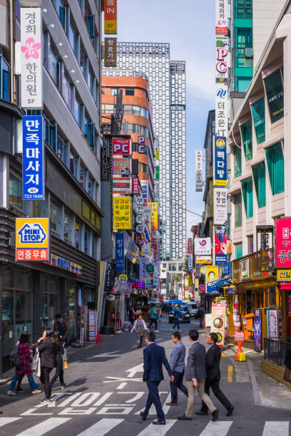 Office workers and locals walking along the narrow streets of downtown Seoul, South Korea’s vibrant capital city.