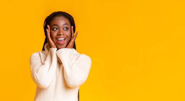 istock Amazed afro girl touching her cheeks, looking at copy space 1187797457
